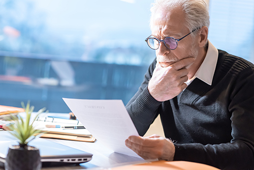 man reading insurance policy that covers wild animal damage